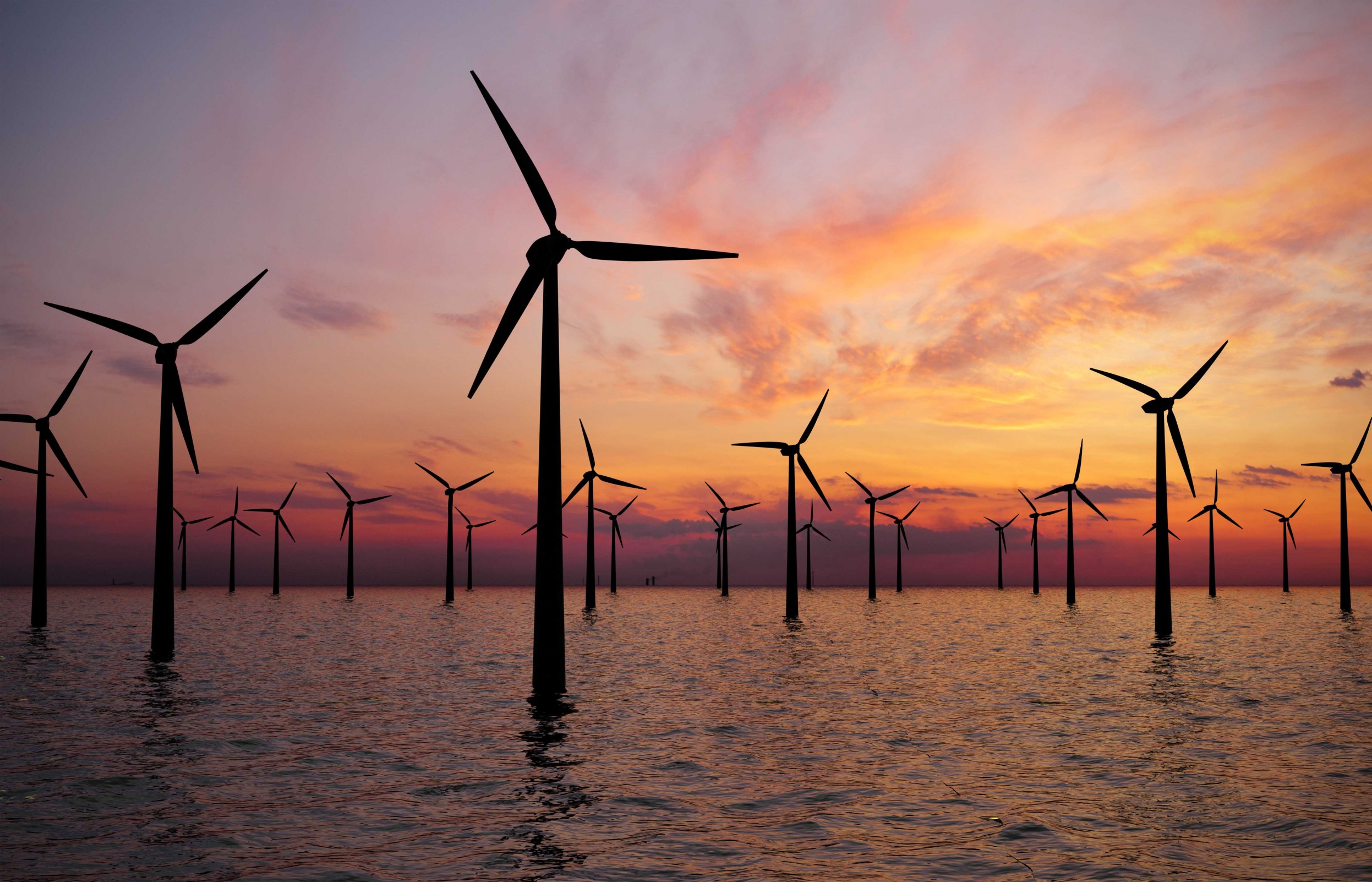 Offshore wind turbines at sunset